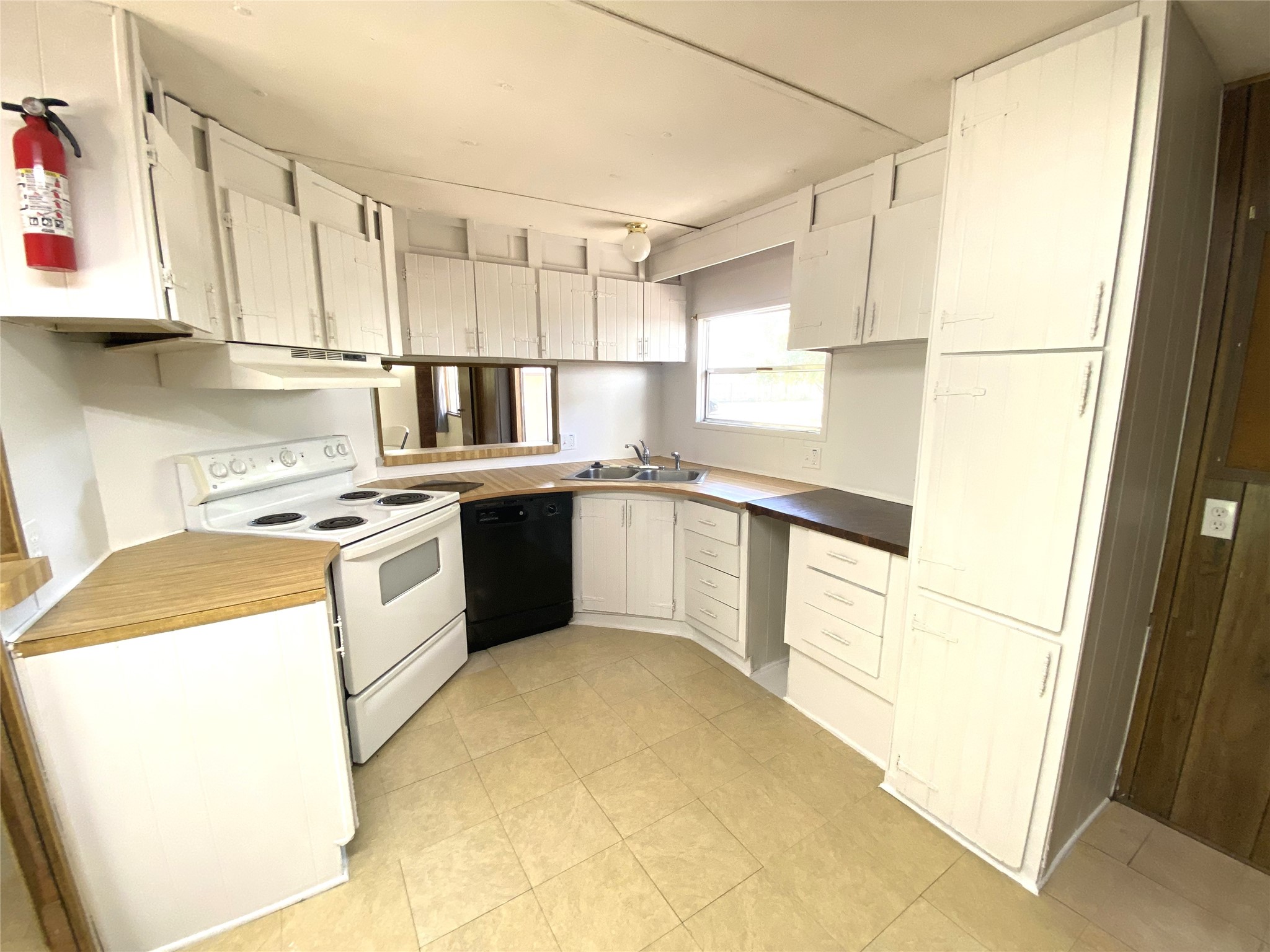 14662 Brooks Road Conroe, TX 77302 - Photo 16 of 23 a kitchen with stainless steel appliances granite countertop a sink a stove a refrigerator with white cabinets
