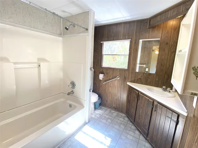 a bathroom with a bathtub a toilet and a shower