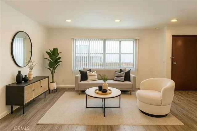a living room with furniture a flat screen tv and a large window