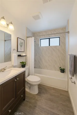 a bathroom with a sink a toilet and bathtub