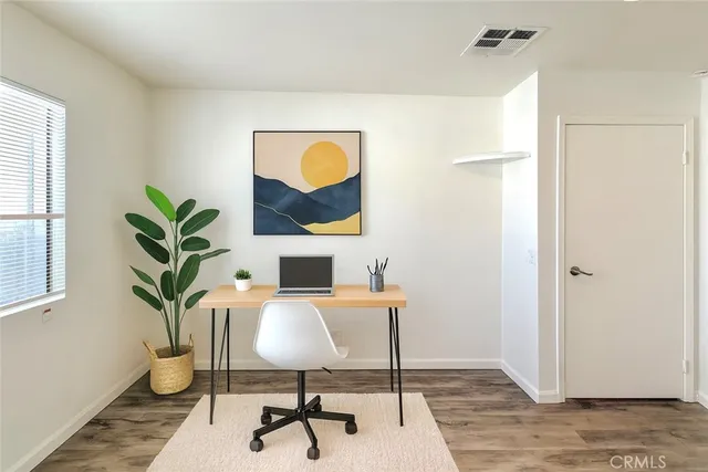 a work room with furniture and wooden floor