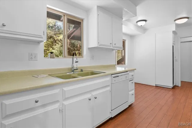 a kitchen with white cabinets and white appliances