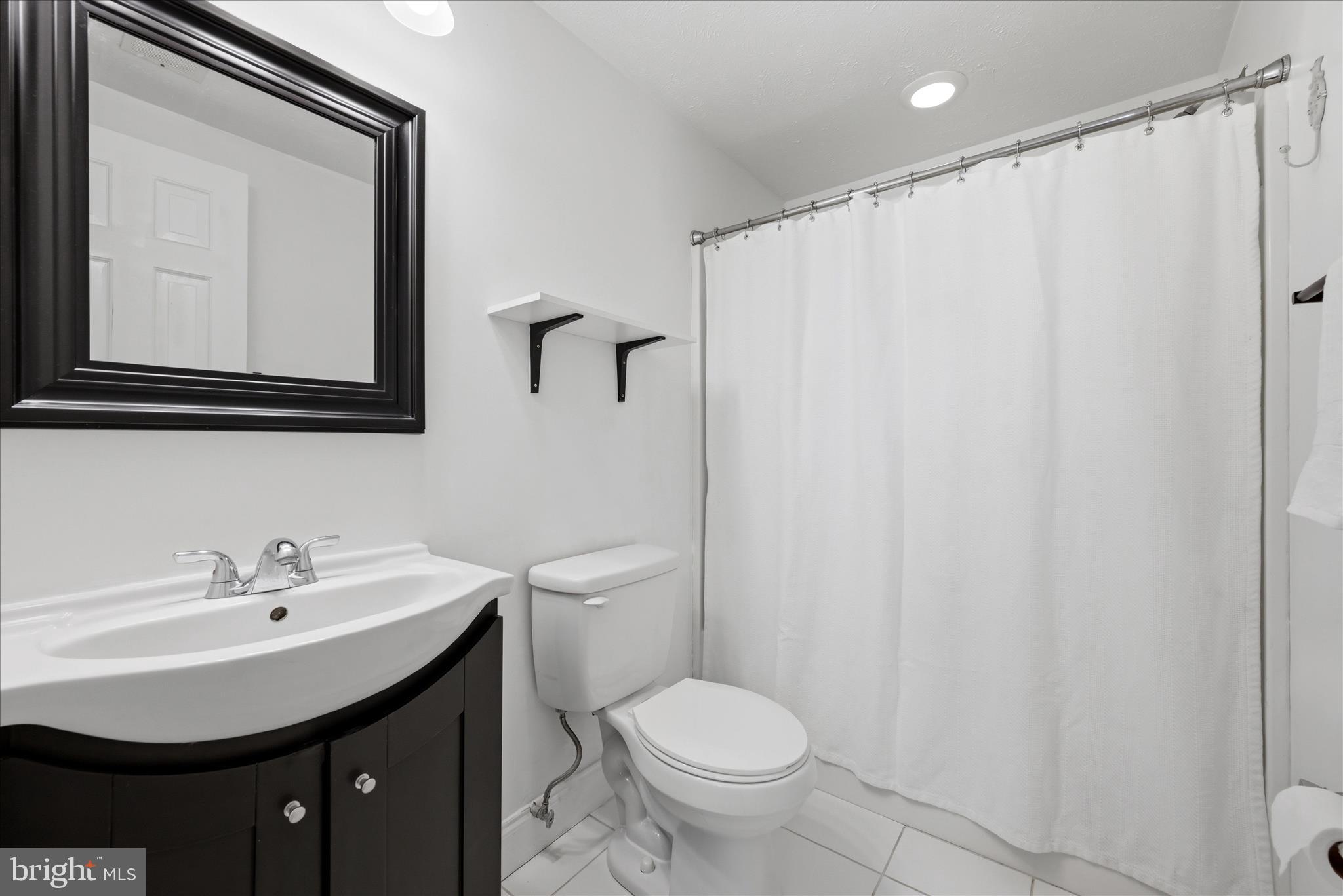 3744 Browntown Road Front Royal, VA 22630 - Photo 59 of 84 a bathroom with a sink mirror and toilet