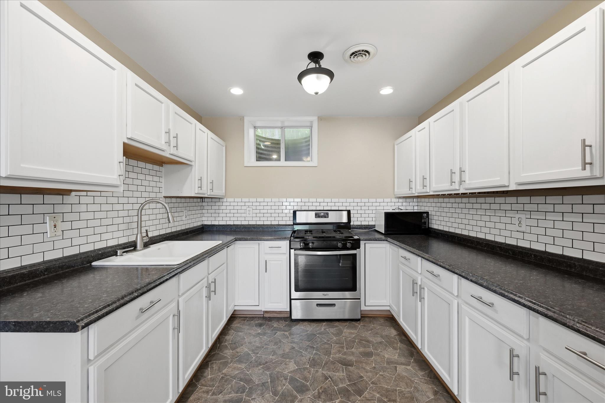 3744 Browntown Road Front Royal, VA 22630 - Photo 60 of 84 a kitchen with granite countertop white cabinets and white appliances