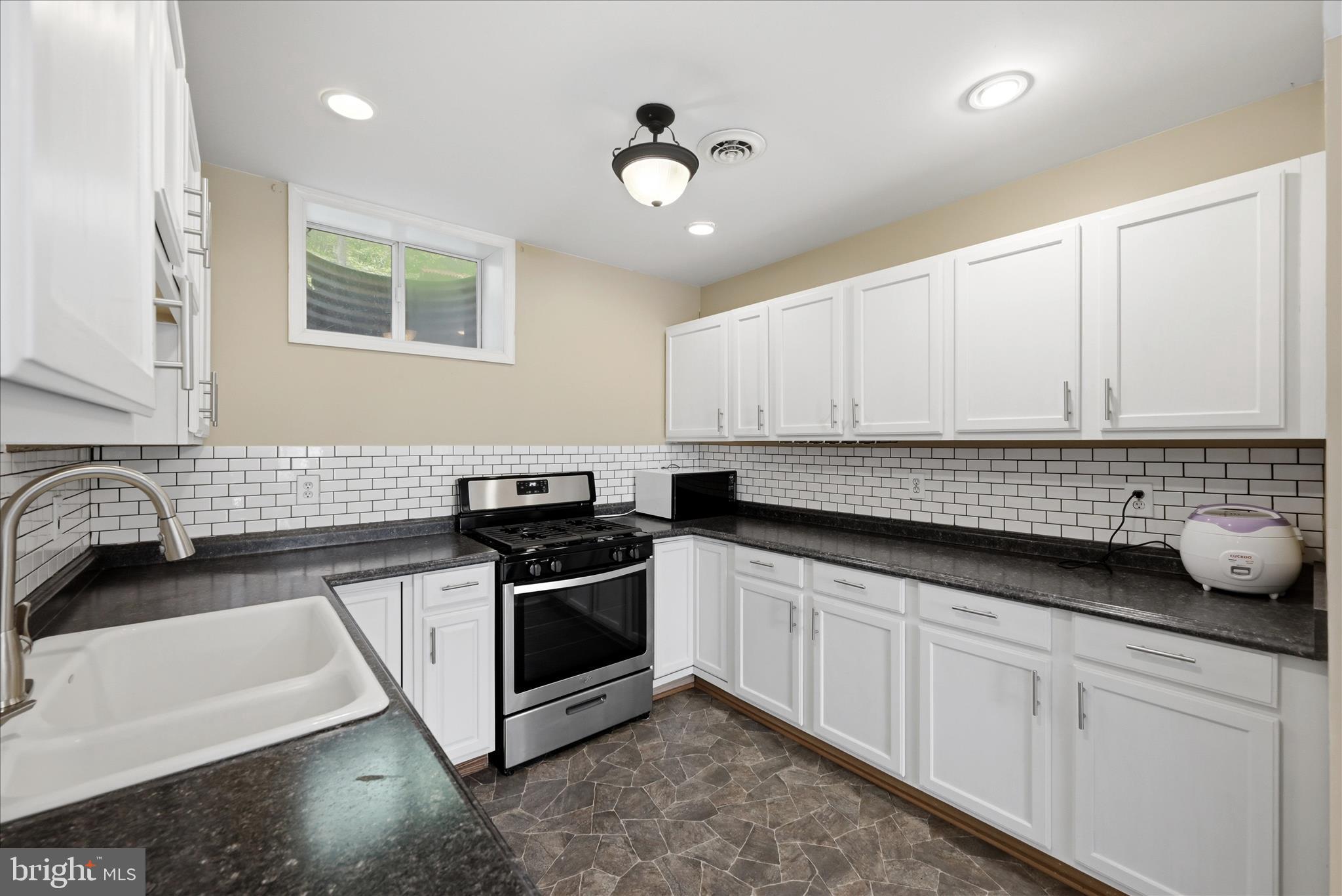 3744 Browntown Road Front Royal, VA 22630 - Photo 61 of 84 a kitchen with granite countertop a stove sink and cabinets