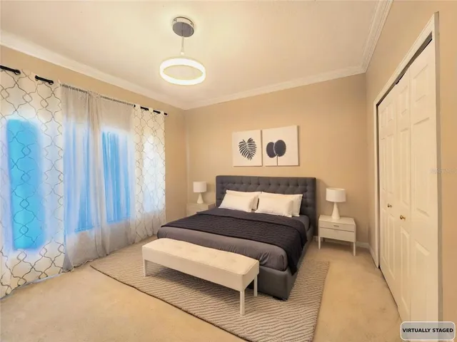 a bedroom with a bed and a chandelier