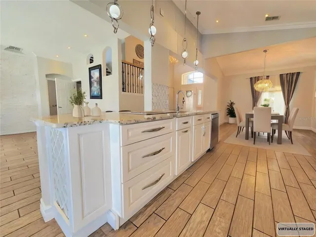 a large room with lots of counter space and windows