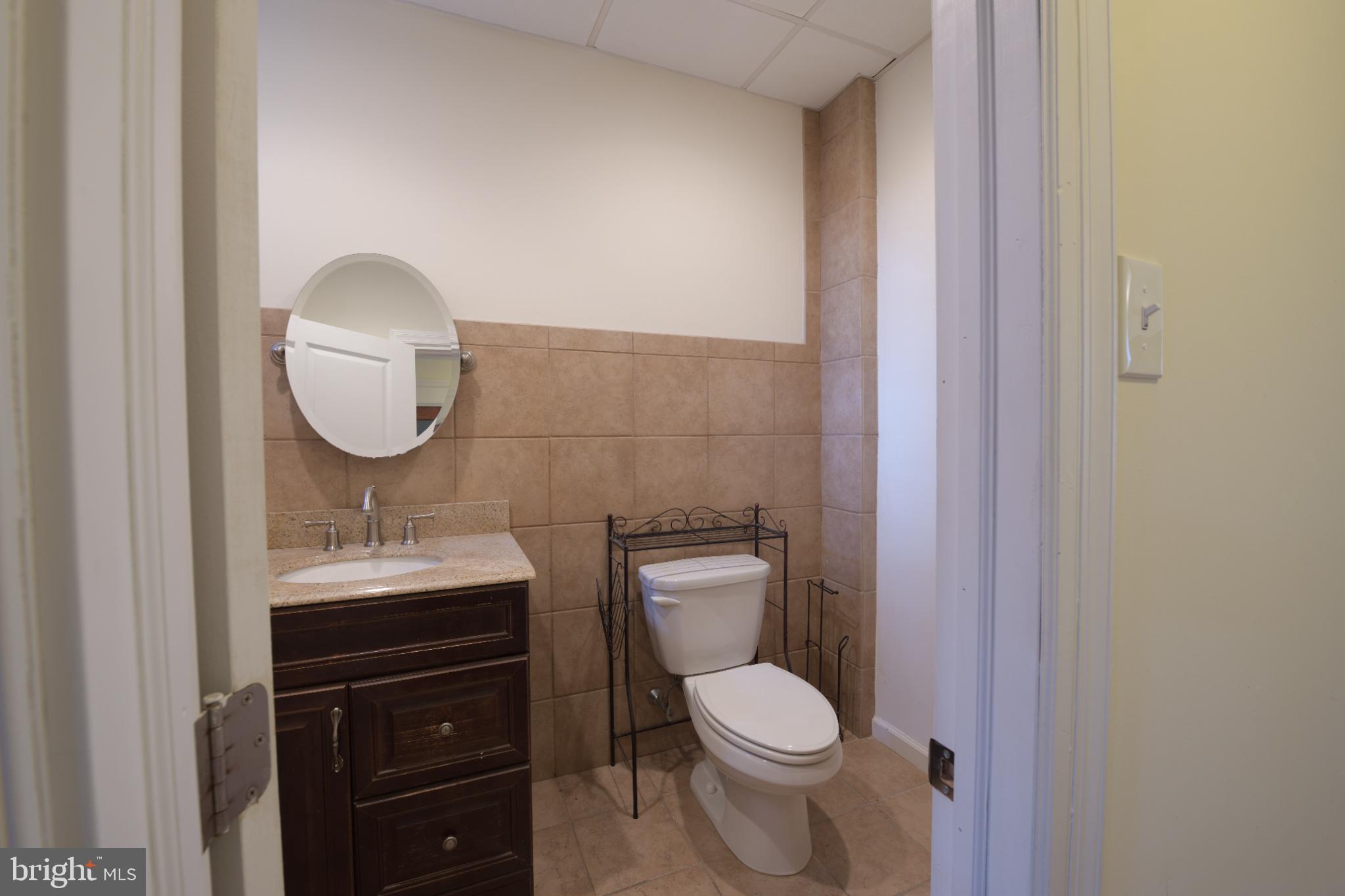 1547 South 13th Street, Unit 2&3 Philadelphia, PA 19147 - Photo 14 of 18 a bathroom with a toilet a sink and mirror