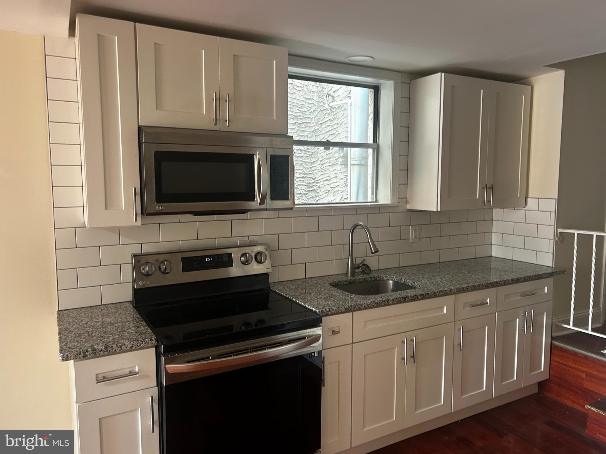 1547 South 13th Street, Unit 2&3 Philadelphia, PA 19147 - Photo 6 of 18 a kitchen with granite countertop white cabinets appliances and a window