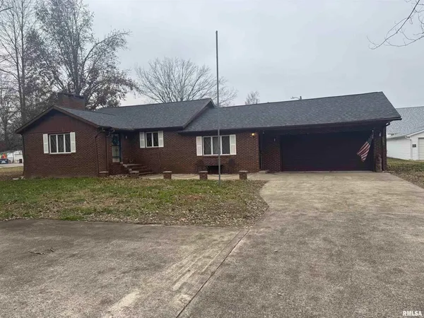 a front view of house with a garden