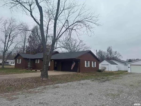 a house that has a tree in front of it