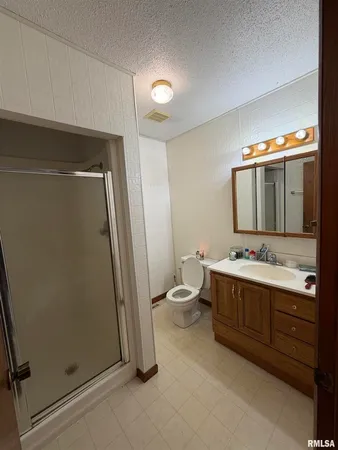 a bathroom with a double vanity sink mirror and toilet