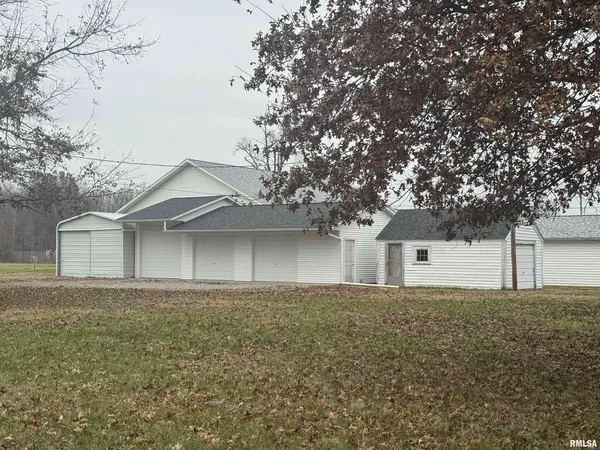 a front view of house with yard and trees