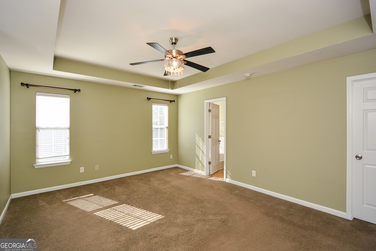137 Baywood Crossing Hiram, GA 30141 - Photo 27 of 61 a view of an empty room and window and a ceiling fan