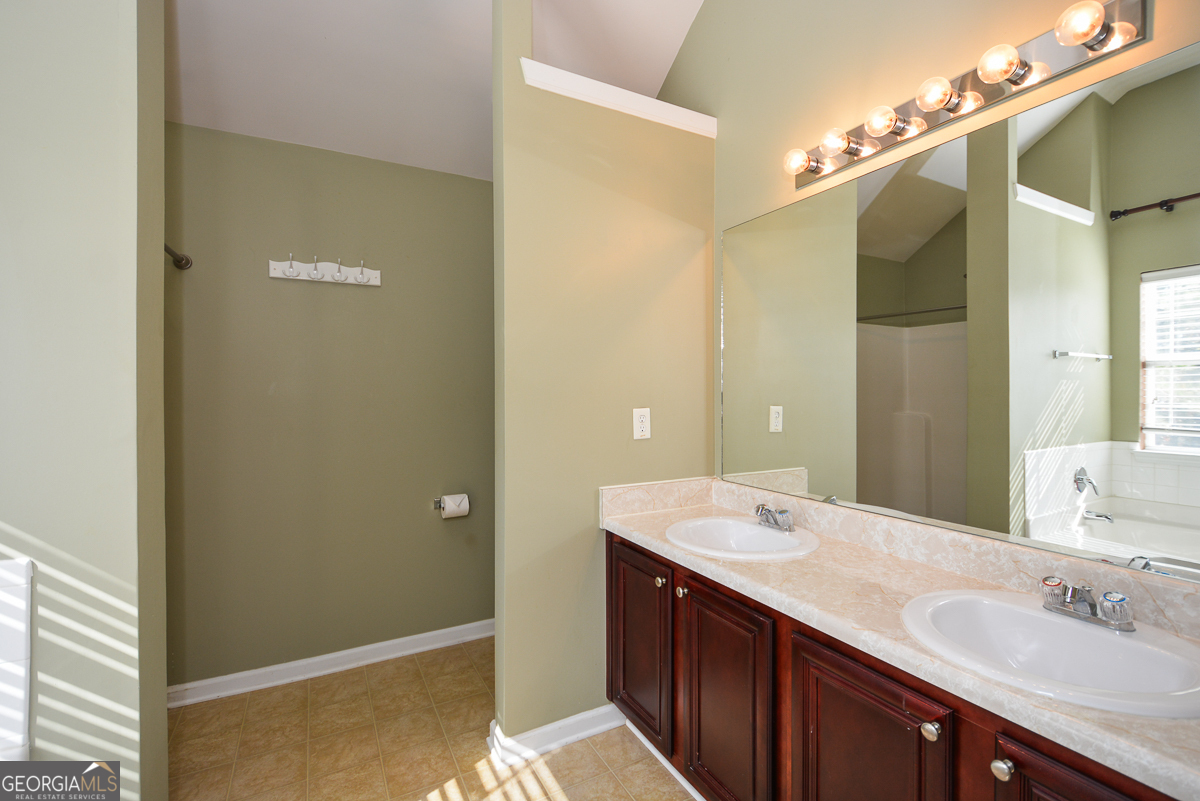 137 Baywood Crossing Hiram, GA 30141 - Photo 32 of 61 a bathroom with a double vanity sink and a mirror