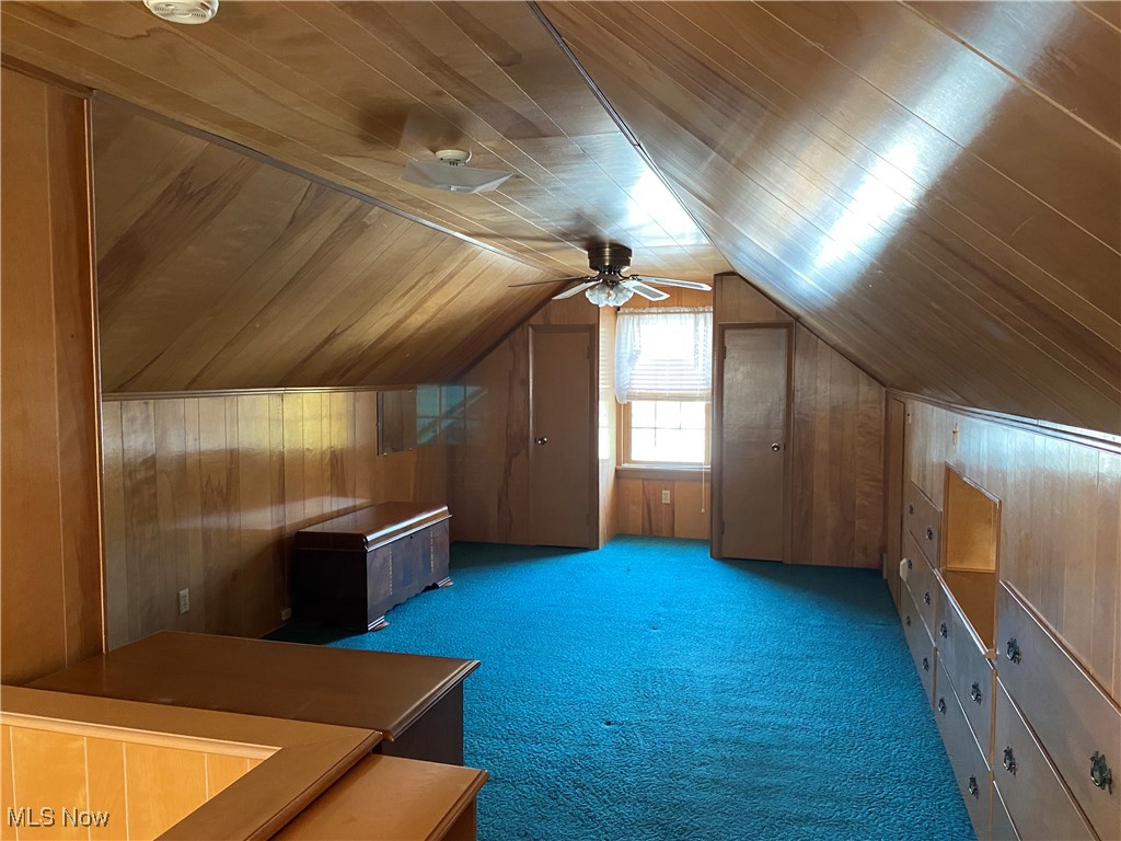 421 Omar Street Struthers, OH 44471 - Photo 16 of 31 Bonus room featuring ceiling fan, lofted ceiling, carpet floors, and wooden walls