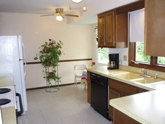 3843 Abbotsford Road Rockford, IL 61107 - Photo 7 of 8 a kitchen with a sink refrigerator and microwave