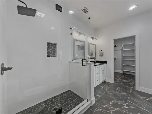 a large white kitchen with a sink a refrigerator and a stove