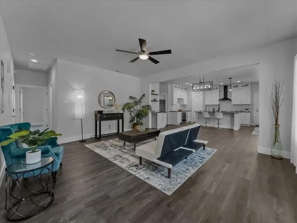 a living room with furniture and a wooden floor