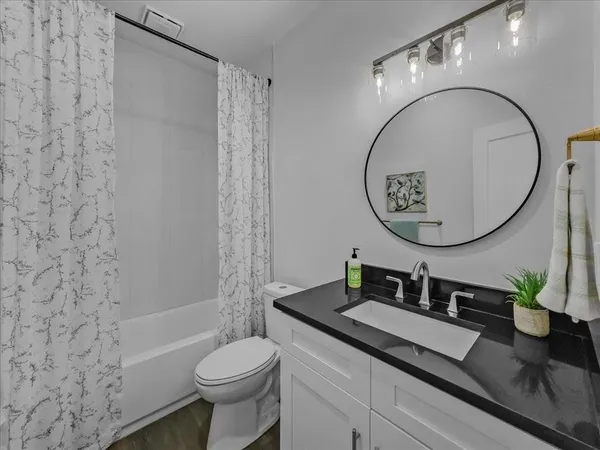 a bathroom with a sink a toilet and a mirror