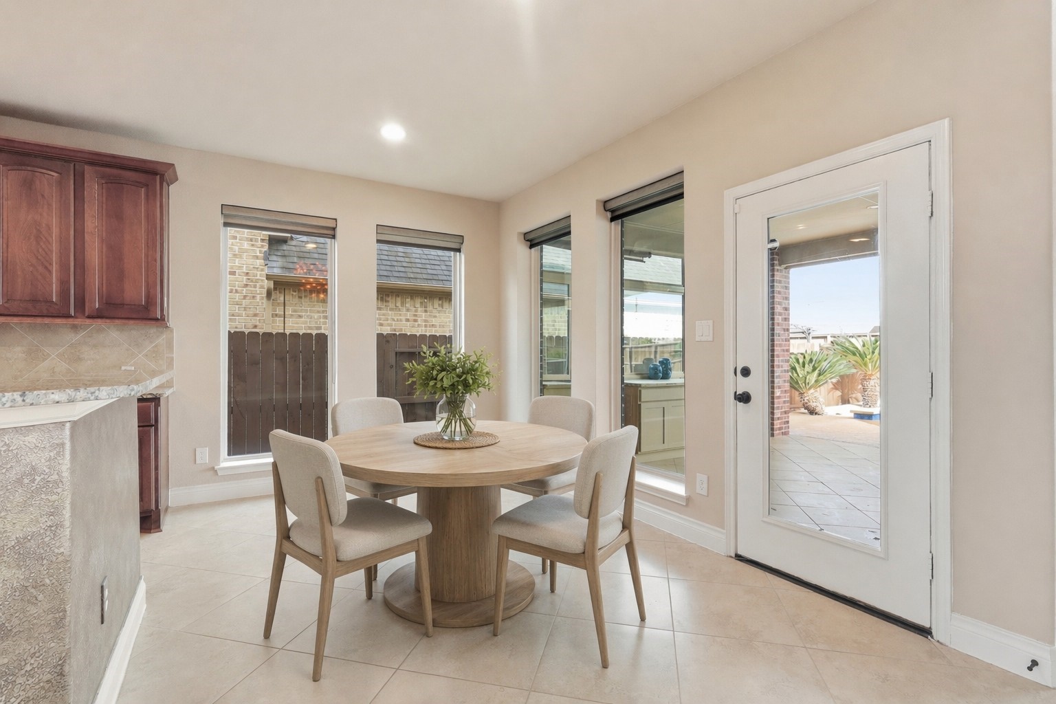 4130 Clover Ridge Lane Sugar Land, TX 77479 - Photo 10 of 48 Bright dining area with tiled flooring, large windows and a glass door offer natural light and a view of the patio for indoor/otdoor living.