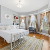 a spacious bedroom with a bed and a large window
