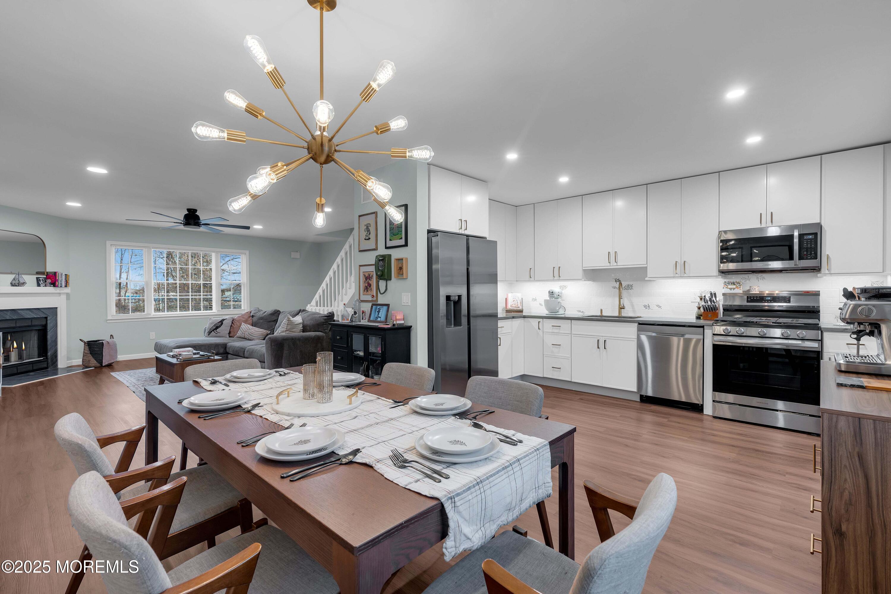 13 Dutch Lane Hazlet, NJ 07730 - Photo 13 of 28 a kitchen with a dining table cabinets appliances and wooden floor