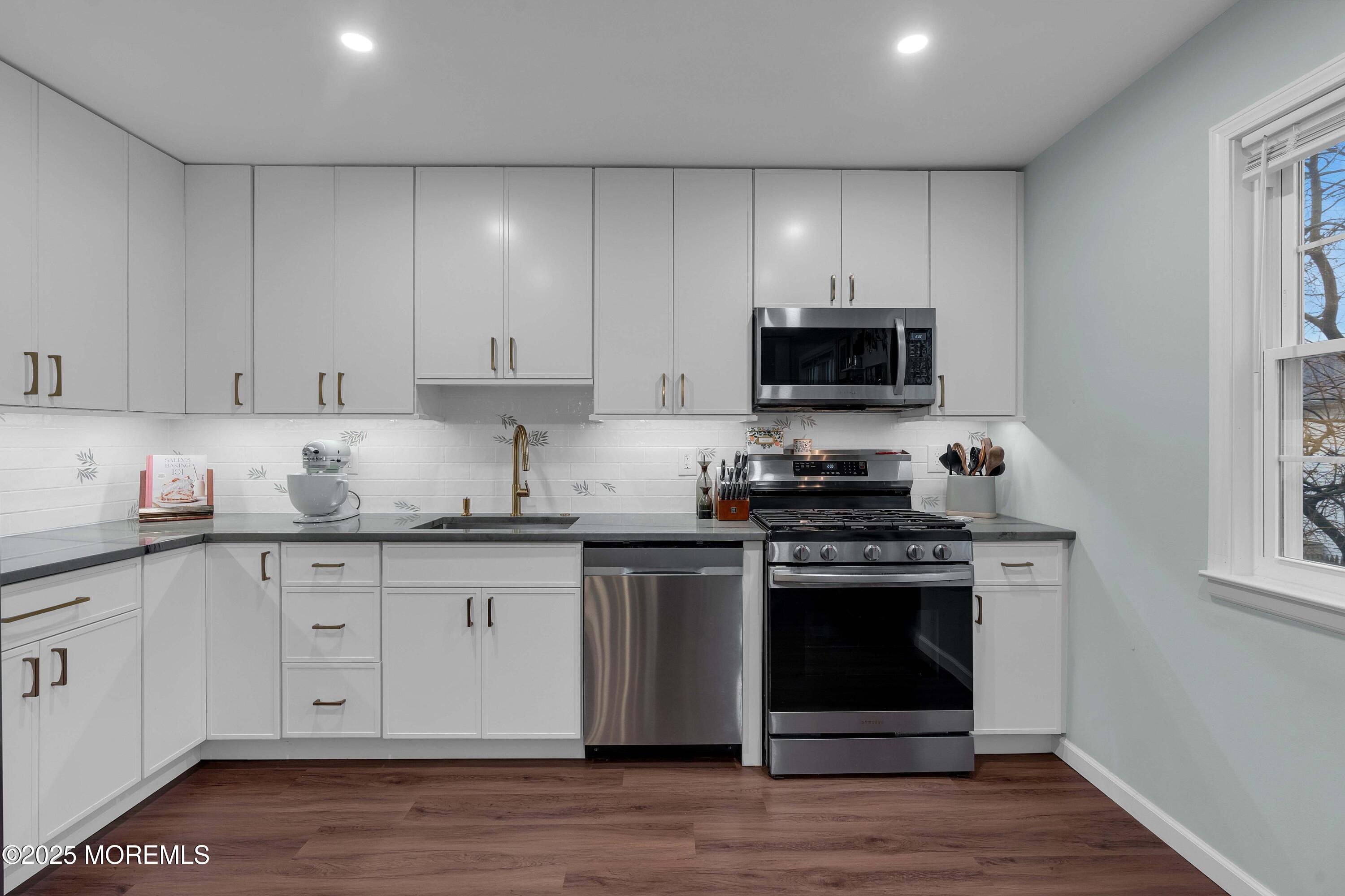 13 Dutch Lane Hazlet, NJ 07730 - Photo 15 of 28 a kitchen with granite countertop white cabinets and black appliances