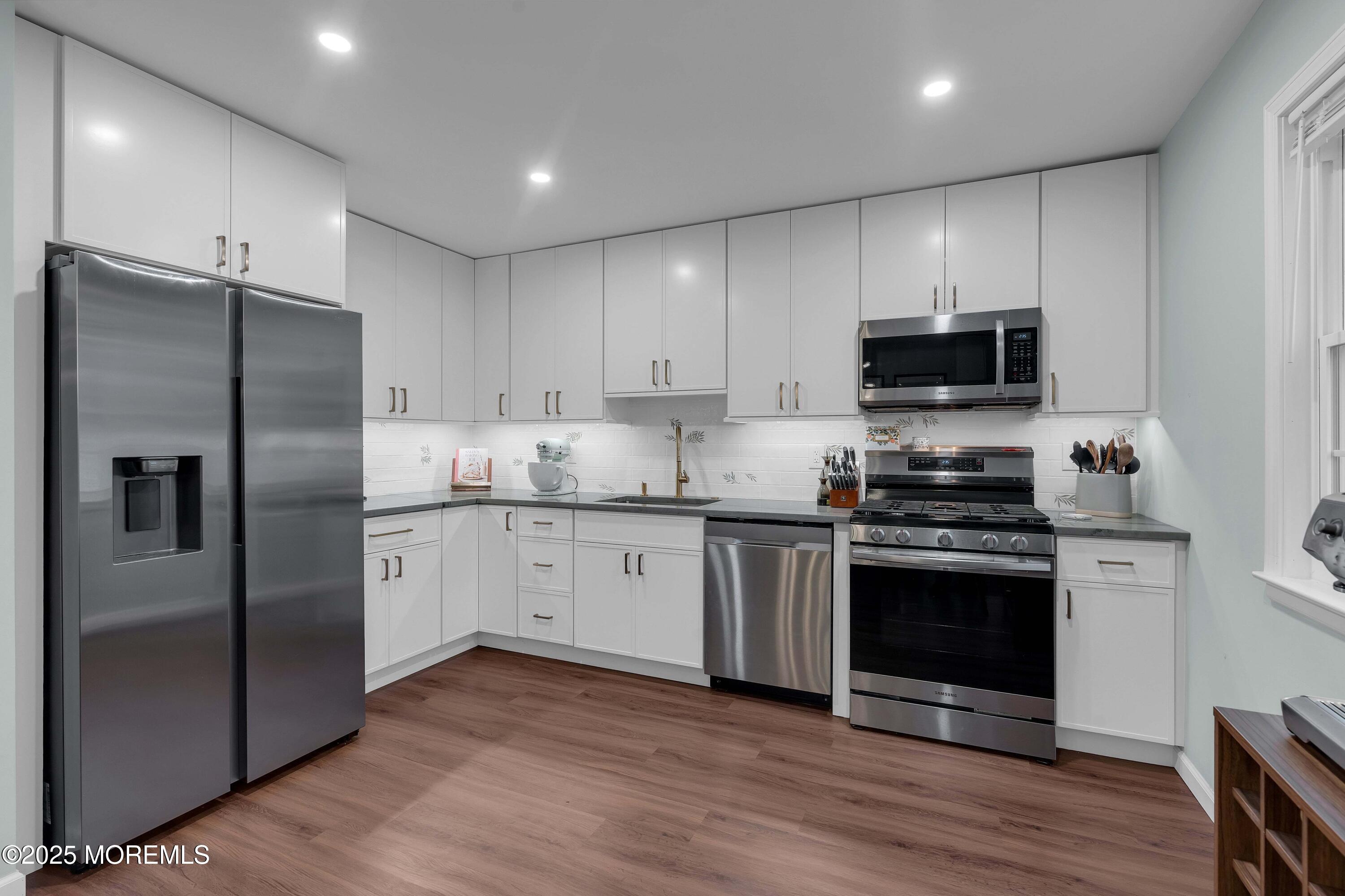 13 Dutch Lane Hazlet, NJ 07730 - Photo 17 of 28 a kitchen with stainless steel appliances a refrigerator sink and microwave