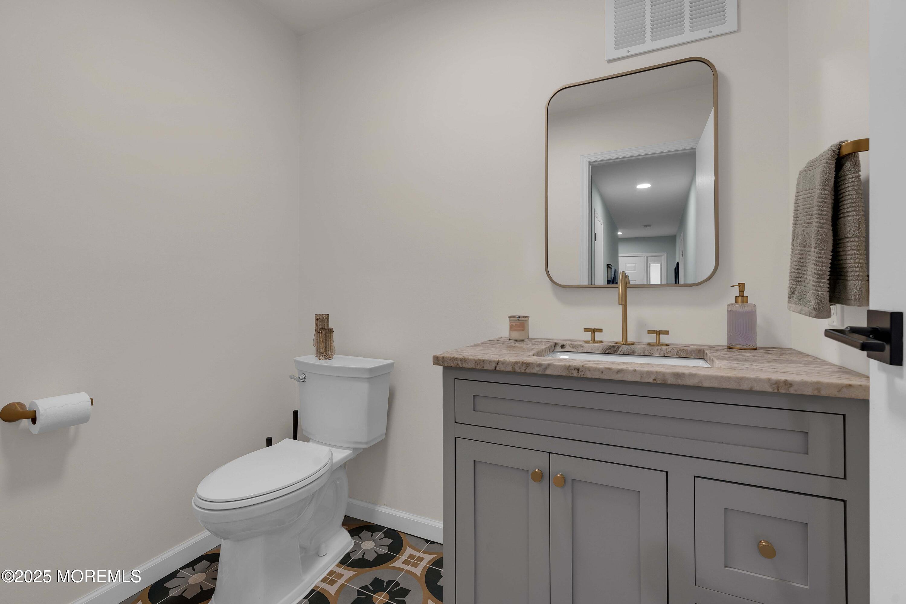 13 Dutch Lane Hazlet, NJ 07730 - Photo 19 of 28 a bathroom with a toilet a sink and mirror
