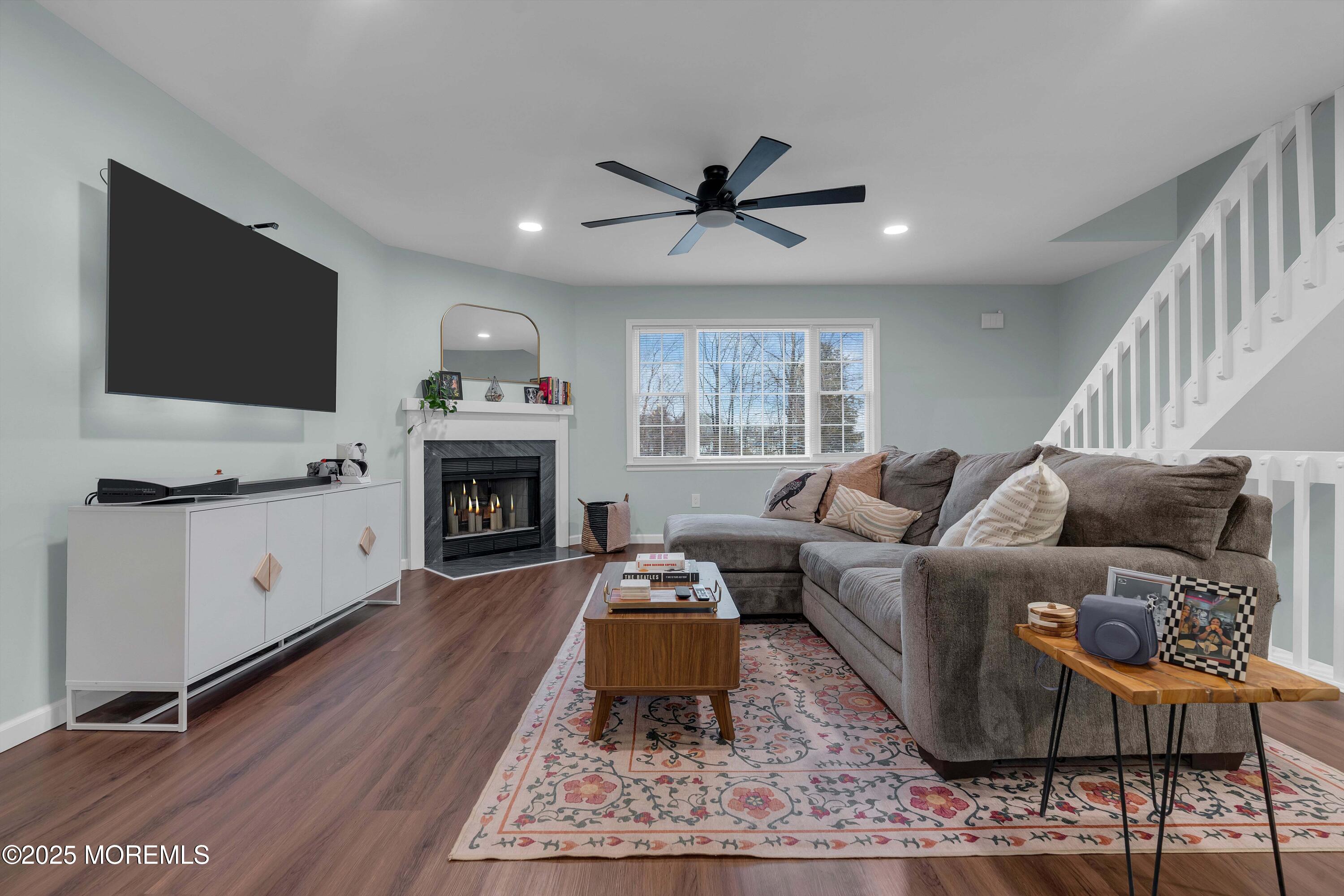 13 Dutch Lane Hazlet, NJ 07730 - Photo 5 of 28 a living room with furniture a flat screen tv and a fireplace