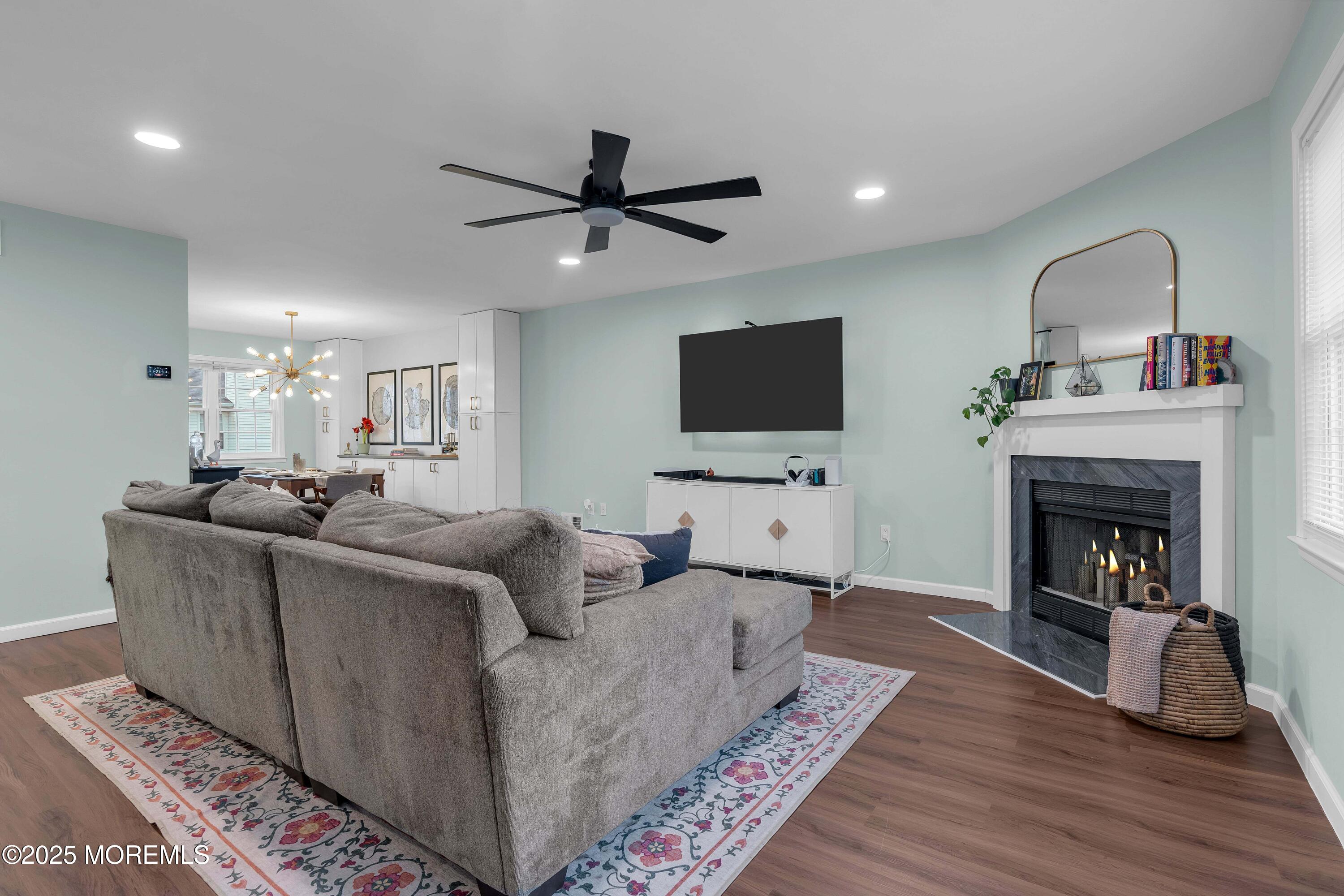 13 Dutch Lane Hazlet, NJ 07730 - Photo 7 of 28 a living room with furniture a flat screen tv and a fireplace