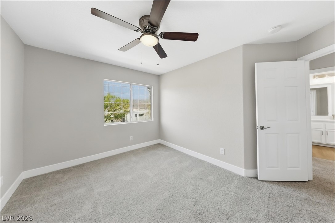 1906 Cardinal Point Street Henderson, NV 89012 - Photo 16 of 20 Soft carpeting pairs with a multi-pane window in this comfortable secondary bedroom.