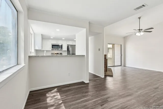 a view of a kitchen with a sink and a window