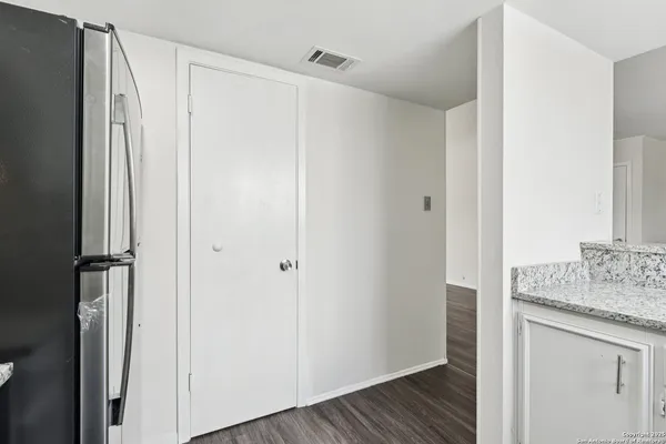 a bathroom with a granite countertop sink and shower
