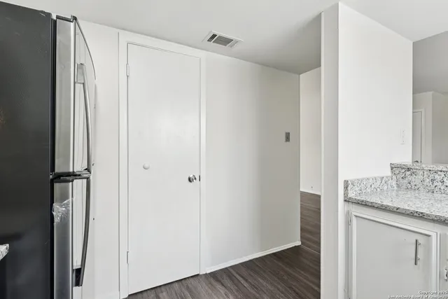 a bathroom with a granite countertop sink and shower