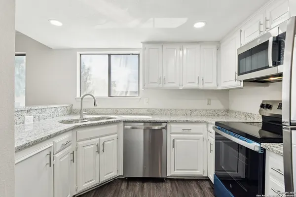 a kitchen with appliances cabinets and a sink