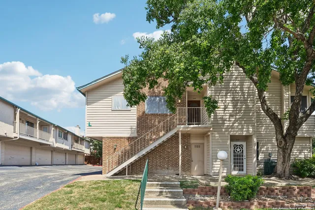 a view of a house with a tree