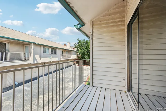a view of a balcony with wooden floor
