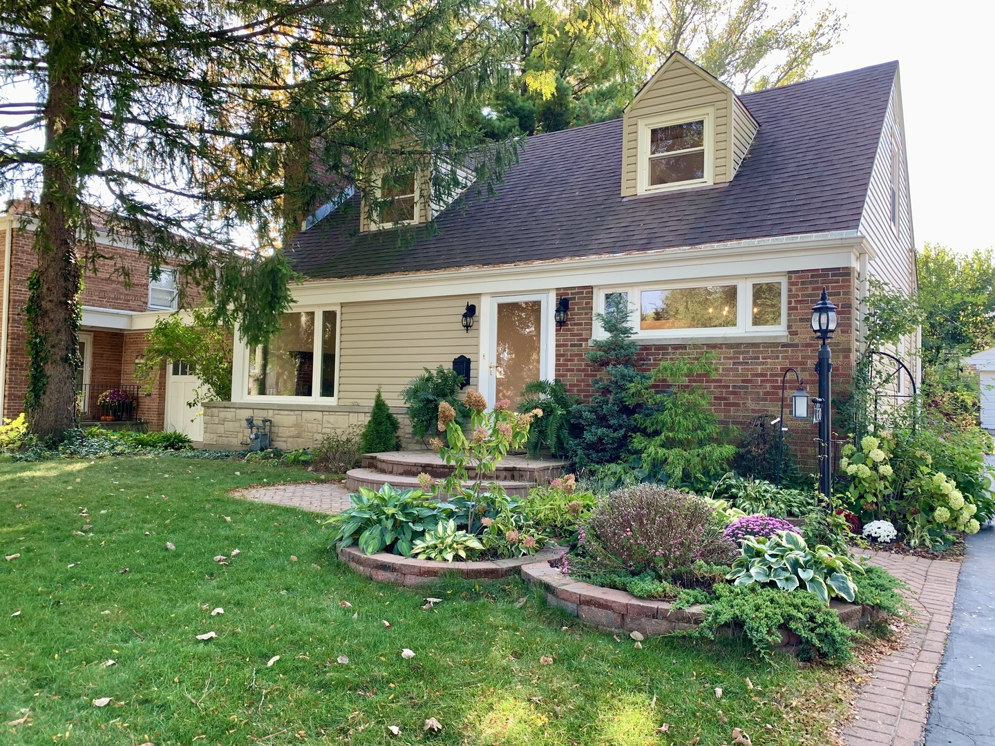 a front view of a house with a yard and outdoor seating
