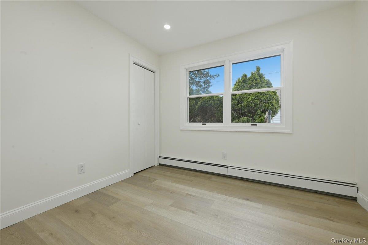 84 North Fordham Road Hicksville, NY 11801 - Photo 13 of 28 an empty room with a window