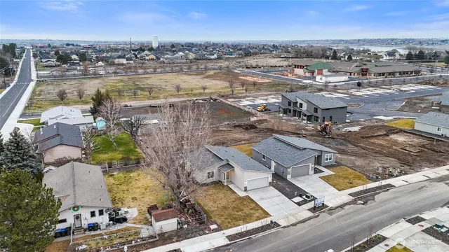 a view of kitchen with kitchen island wooden floor appliances and cabinets