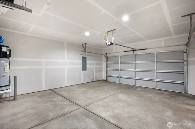 a large kitchen with kitchen island a sink wooden floor and stainless steel appliances