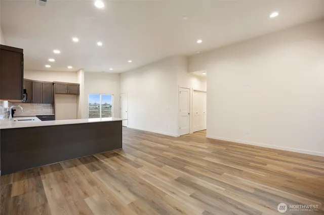a kitchen with granite countertop a sink stove and refrigerator