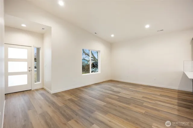 a room with wooden floors and wooden cabinets