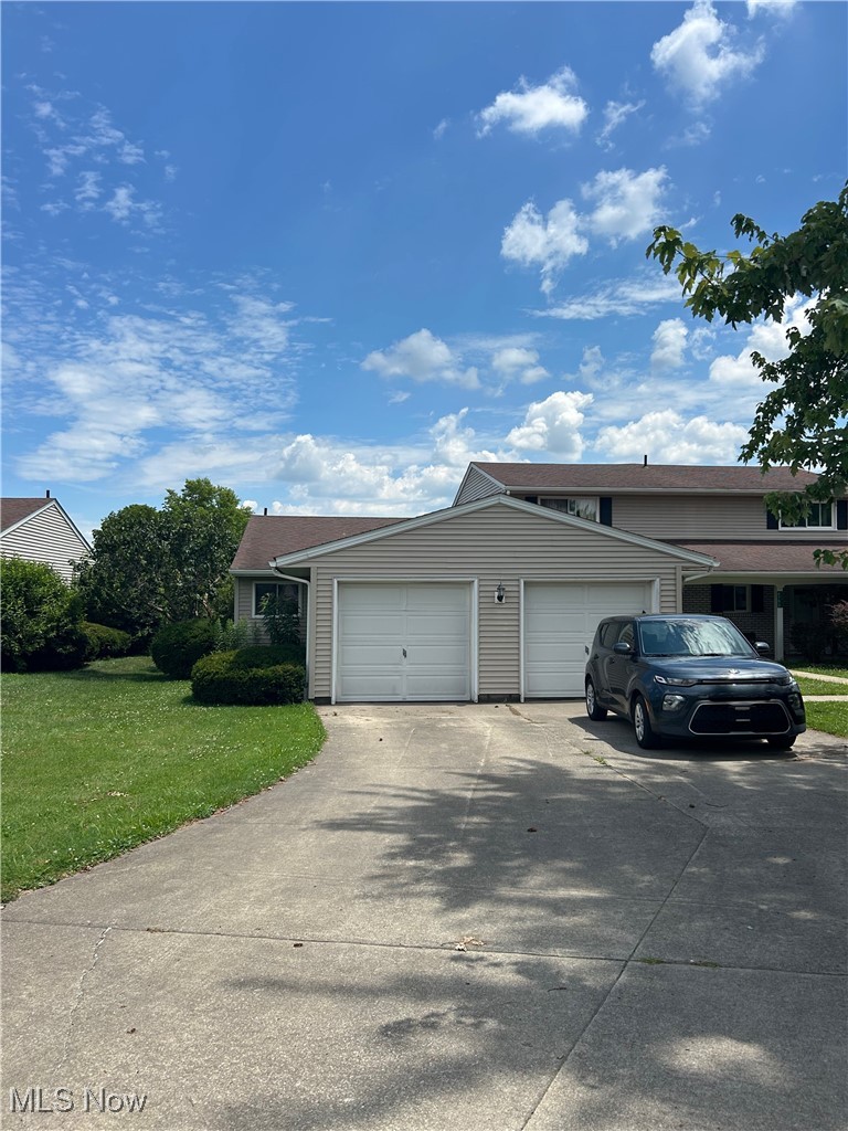 8753 West Ridge Road, Unit A Elyria, OH 44035 - Photo 1 of 21 View of front of home featuring an attached garage, driveway, and a front lawn