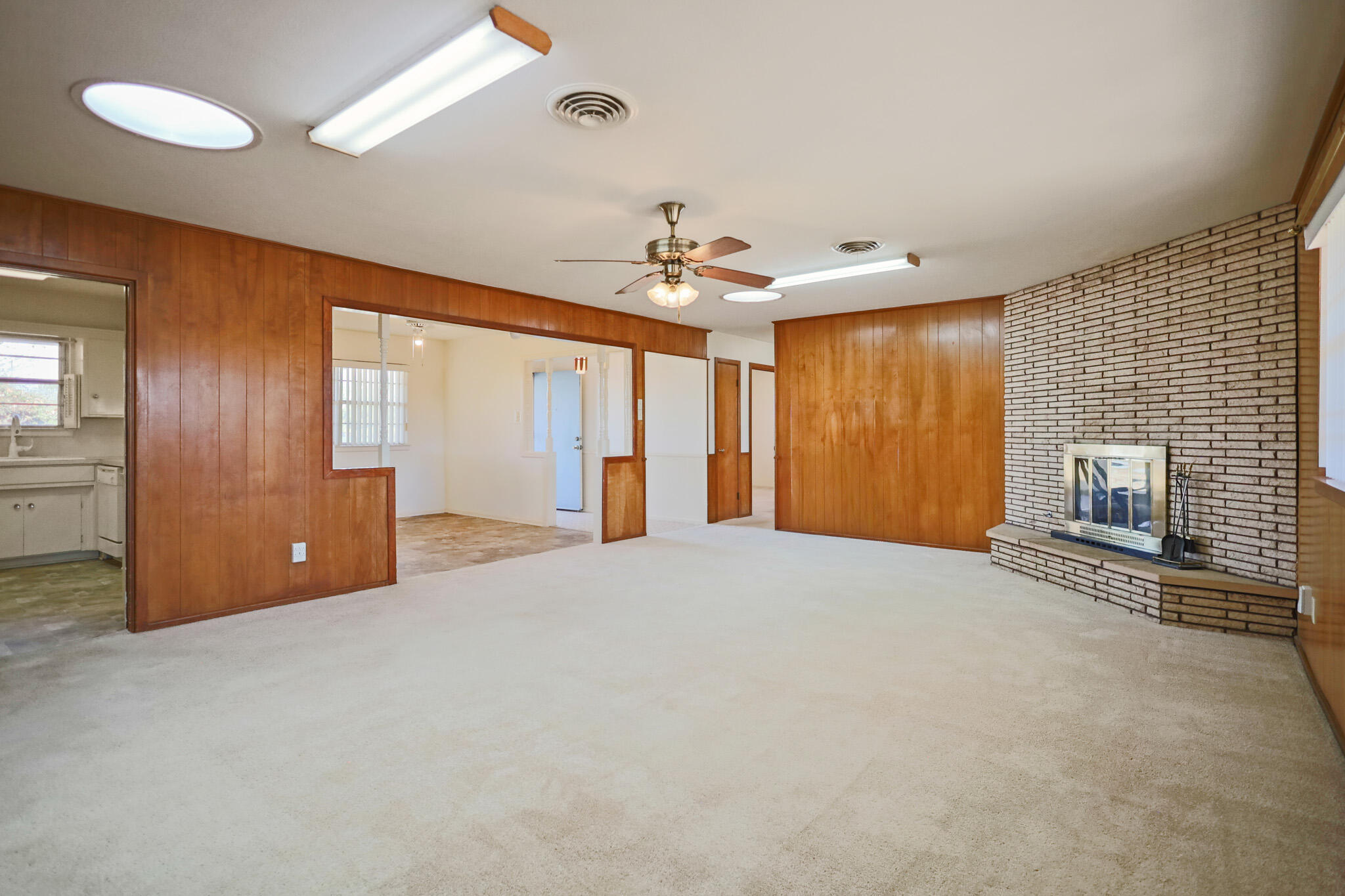 5517 26th Street Lubbock, TX 79407 - Photo 13 of 55 a view of an empty room with a fireplace and a window