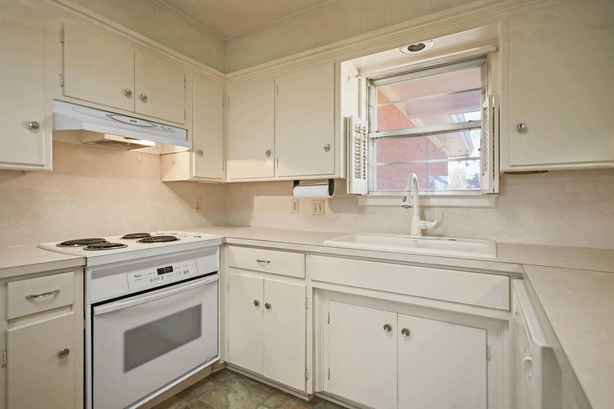 5517 26th Street Lubbock, TX 79407 - Photo 25 of 55 a kitchen with granite countertop white cabinets and white appliances