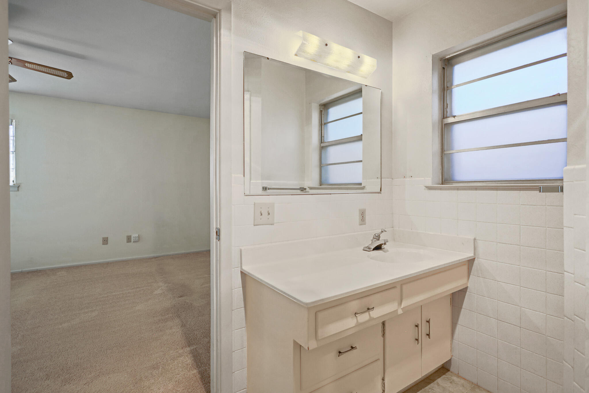 5517 26th Street Lubbock, TX 79407 - Photo 36 of 55 a bathroom with a sink and a mirror
