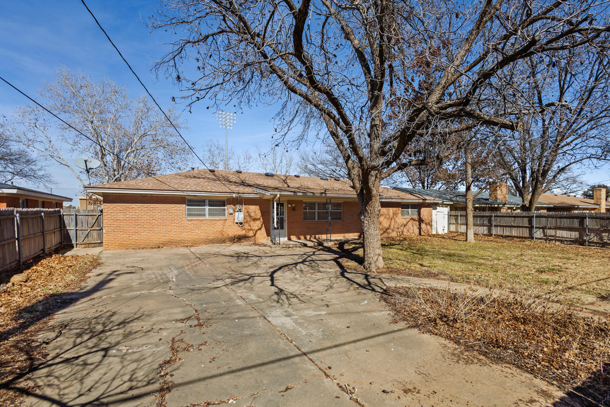 5517 26th Street Lubbock, TX 79407 - Photo 54 of 55 a white house that has a tree in front of it